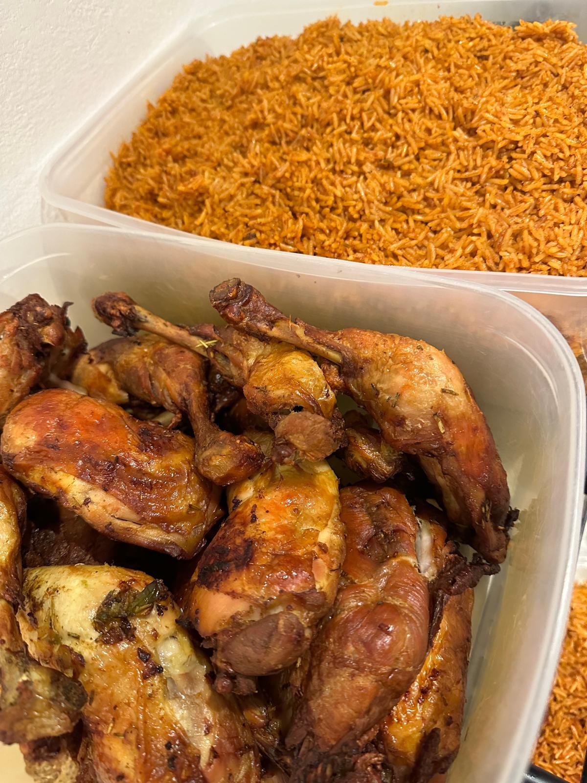 A tray of jollof rice and grilled chicken